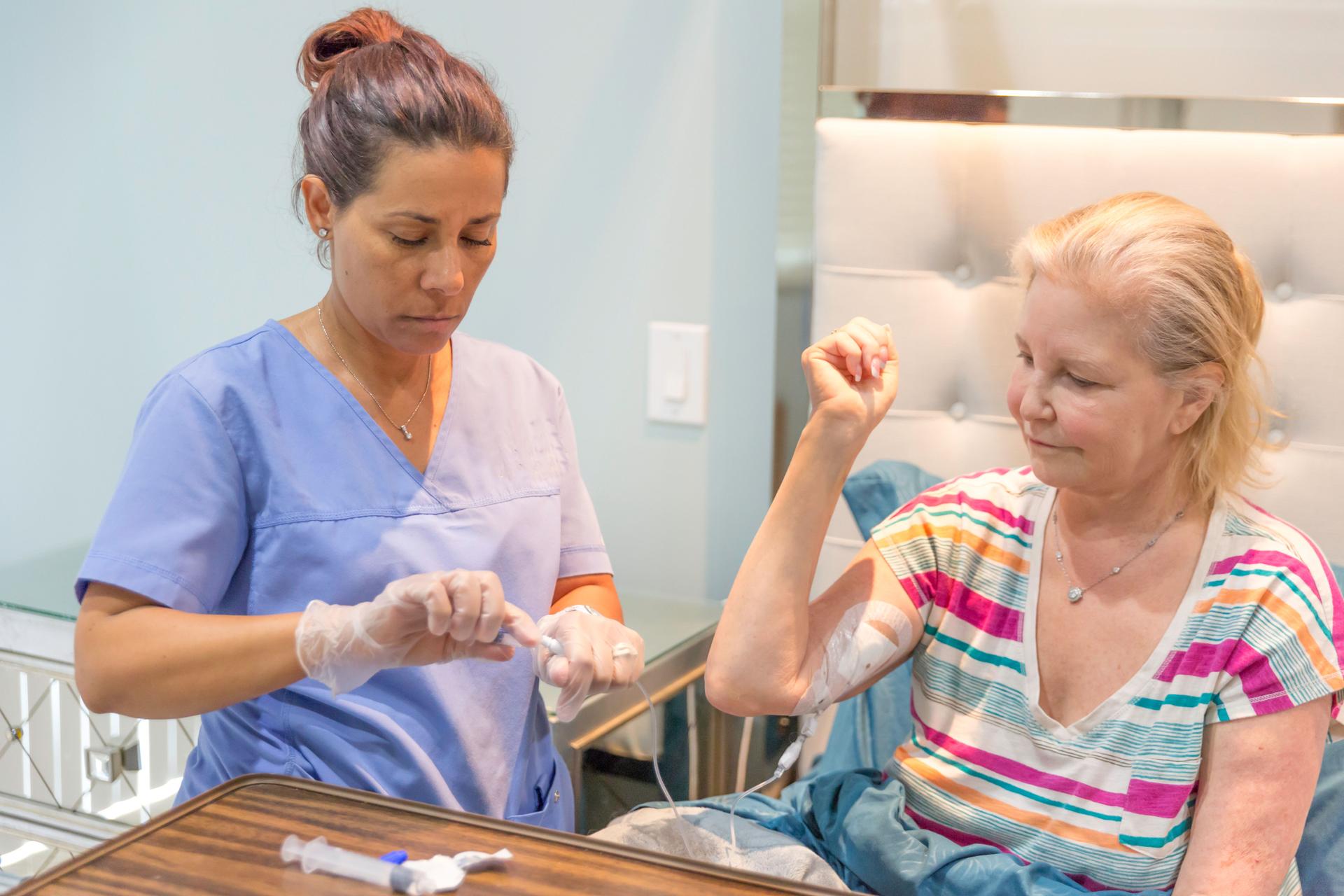 Home healthcare nurse flushing picc line of recovering patient